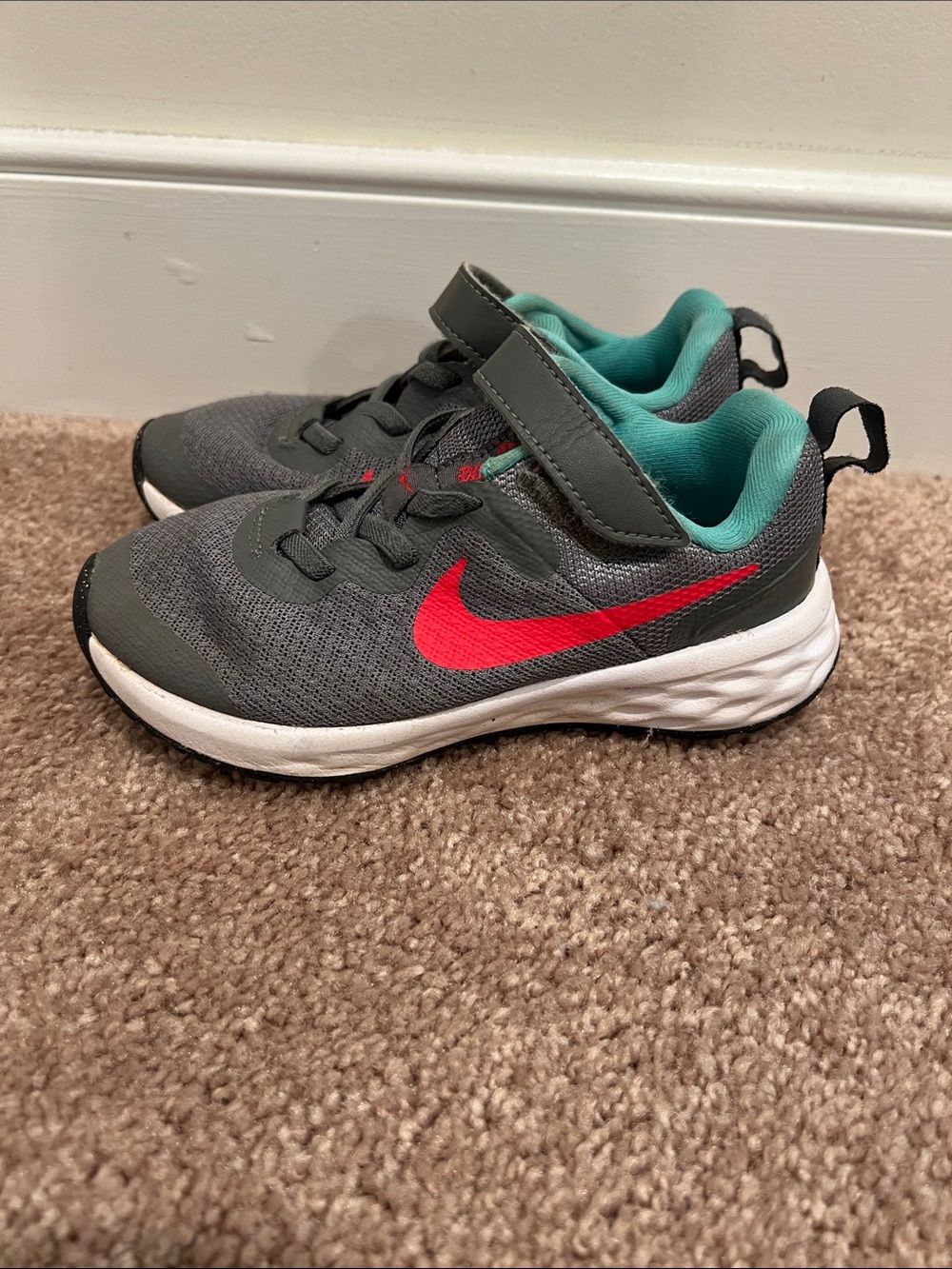 Nike Kids Gray Sneakers with Red Swoosh and Teal Lining